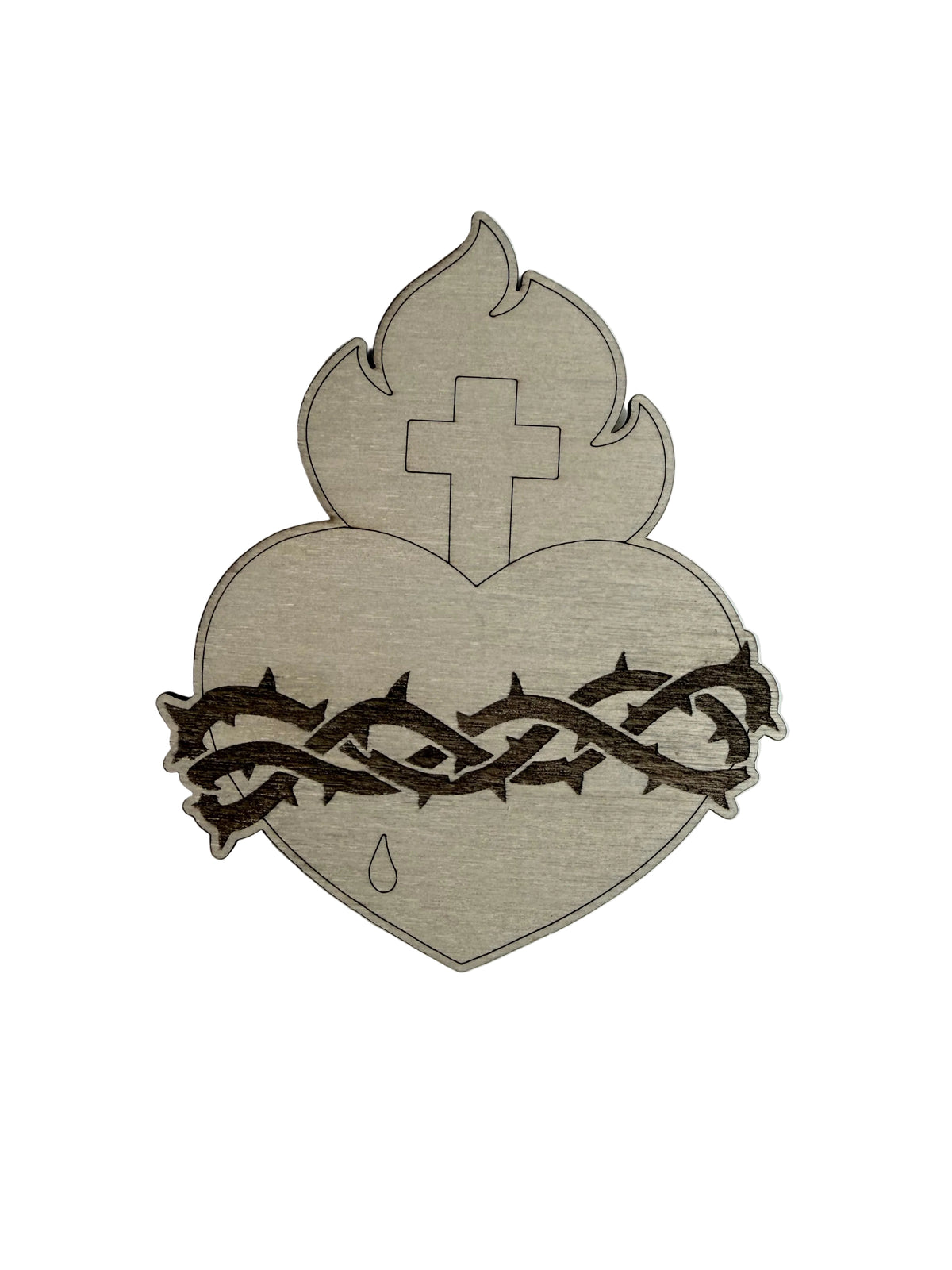 A laser-cut wooden plaque depicting the Sacred Heart of Jesus, featuring a light natural wood heart with a dark brown engraved cross, flame, thorn crown, and tear.